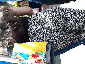 Ass in pants with pattern on the street walking